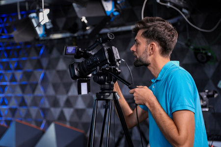 Professional video camera operator working in studioの写真素材