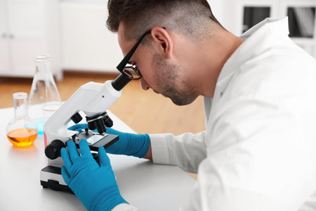 Scientist using modern microscope at table, closeup. medical researchの写真素材