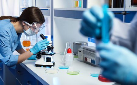 Scientist working with microscope indoors. laboratory analysis