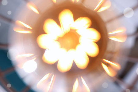 Blurred view of stylish metallic pendant lamp with Edison light bulb, closeup