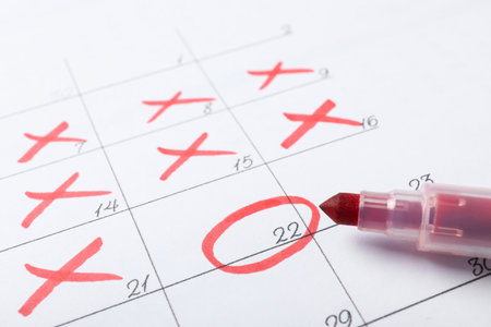 Felt pen on calendar page with marked dates, closeup
