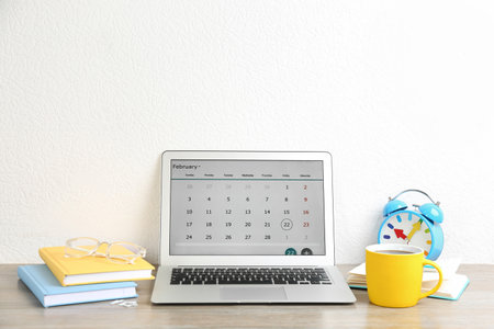 Modern laptop with calendar app in officeの写真素材
