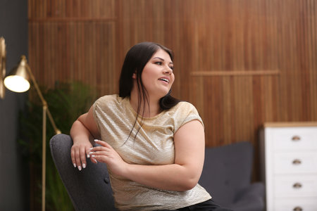 Beautiful overweight woman posing indoors. plus size model