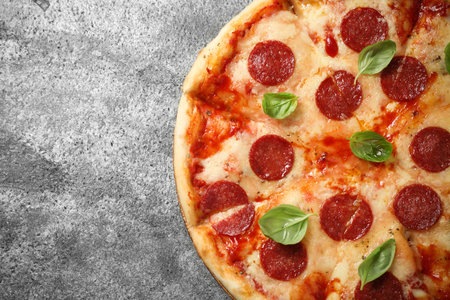 Hot delicious pepperoni pizza on gray table, top view. Space for textの写真素材