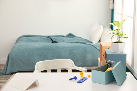 Modern child room interior with desk and comfortable bedの写真素材