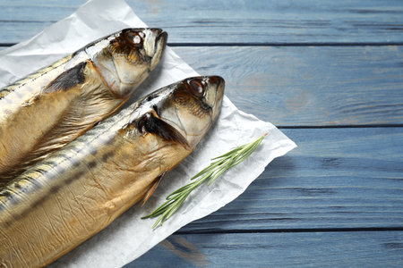 Tasty smoked fish on blue wooden table, closeupの写真素材