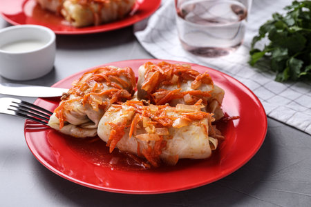 Delicious cabbage rolls served on gray table