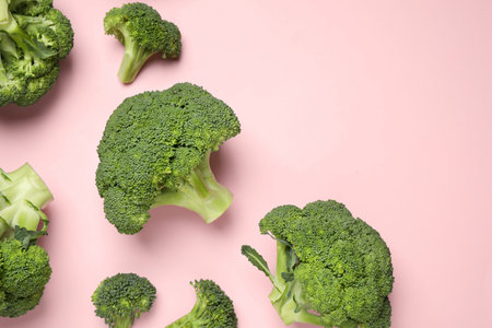 Fresh broccoli on pink background, flat lay. Space for textの写真素材