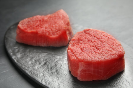 Fresh raw beef cut on black table, closeupの写真素材