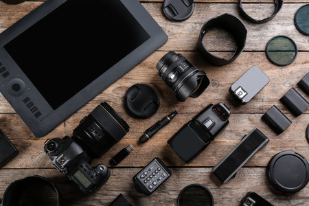 Flat lay composition with equipment for professional photographer on wooden tableの写真素材