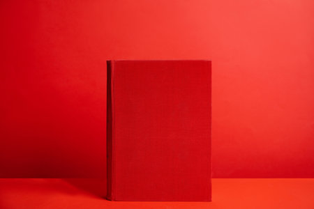 Hardcover book on red background. space for designの写真素材