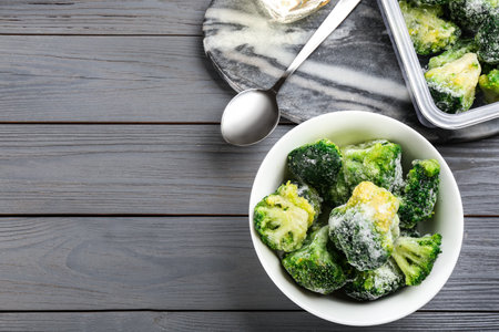 Flat lay composition with frozen broccoli on light gray wooden table, space for text. vegetable preservationの写真素材