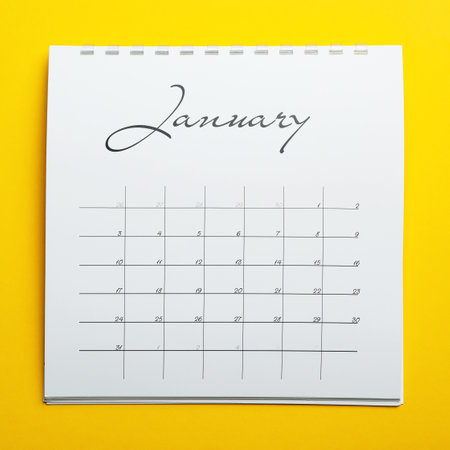 January calendar on yellow background, top viewの写真素材