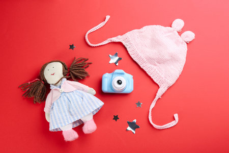 Flat lay composition with little photographer's toy camera on red backgroundの写真素材