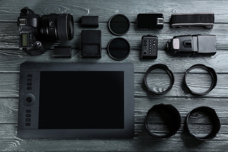 Flat lay composition with equipment for professional photographer on gray wooden tableの写真素材