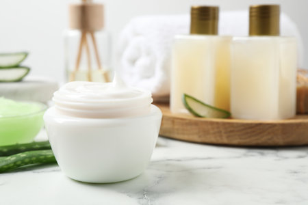 Open jar of aloe cream on white marble table. organic cosmeticsの写真素材