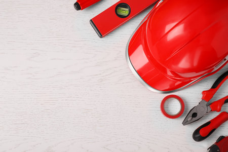 Flat lay composition with construction tools on white wooden background. Space for textの写真素材