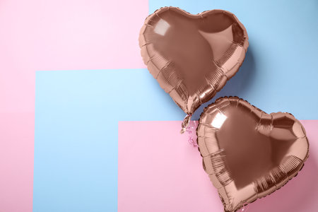 Heart shaped balloons on color background, flat lay. Space for textの写真素材