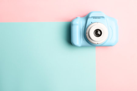 Light blue toy camera on color background, top view with space for text. future photographerの写真素材