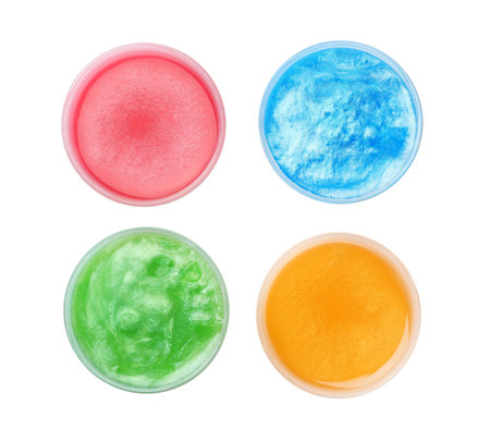 Colorful slimes in plastic containers on white background, top view. antistress toyの写真素材