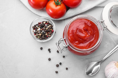 Flat lay composition with tomato sauce on light gray tableの写真素材