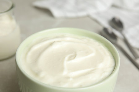 Tasty organic yogurt in bowl on table, closeupの写真素材