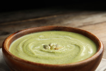 Bowl of delicious broccoli cream soup with pumpkin seeds, closeupの写真素材
