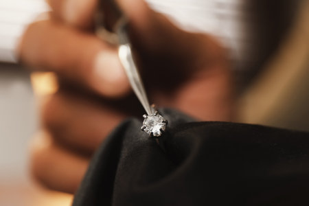 Professional jeweler working with beautiful ring indoors, closeupの写真素材