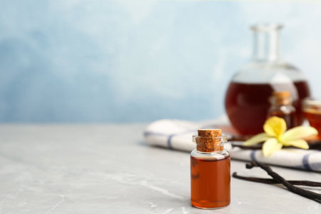 Aromatic homemade vanilla extract on light gray marble table. Space for textの写真素材