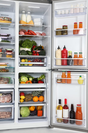 Open refrigerator full of different fresh productsの写真素材