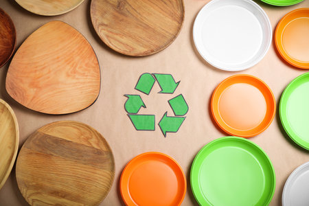 Recycling symbol, plastic and wooden plates on beige background, flat layの写真素材