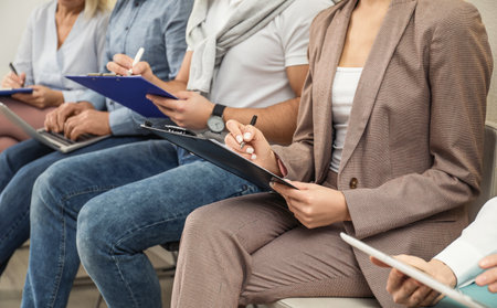 People waiting for job interview in office, closeup
