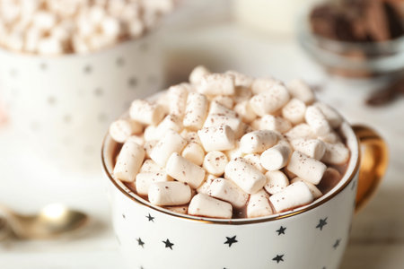 Delicious cocoa drink with marshmallows in cup on table, closeupの写真素材