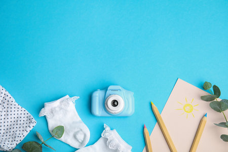 Flat lay composition with toy camera on light blue background, space for text. future photographerの写真素材