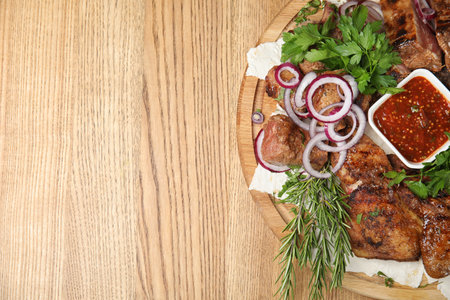 Delicious roasted meat served on wooden table, top view. Space for textの写真素材