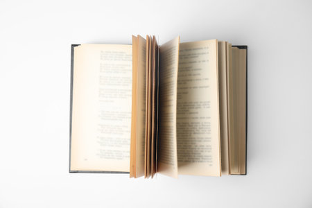 Open book on white background, top view