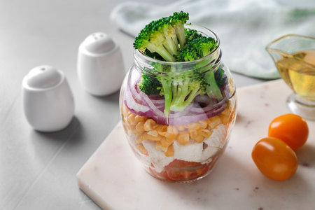 Healthy salad in glass jar on light gray tableの写真素材