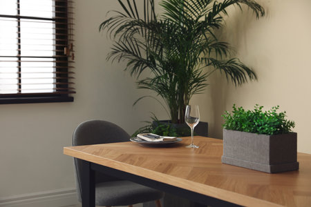 Dishware on wooden table in dining room. Stylish interior