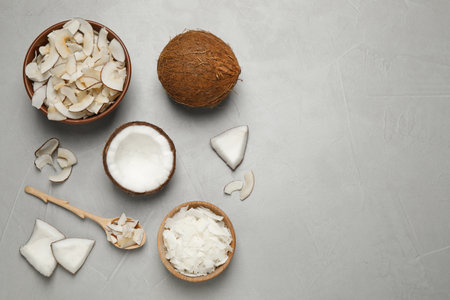 Flat lay composition with tasty coconut chips on gray table. Space for textの写真素材
