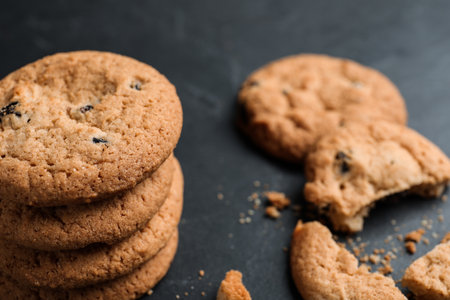 Delicious cookies with raisins on black table, closeupの写真素材