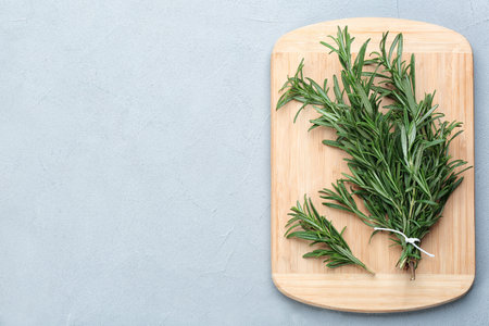 Bunch of fresh rosemary on light gray table, top view. Space for textの写真素材