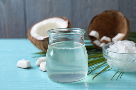 Coconut oil on light blue wooden tableの写真素材