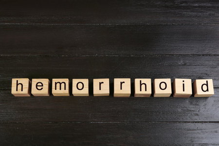 Wooden cubes with word HEMORRHOID on black table, top viewの写真素材