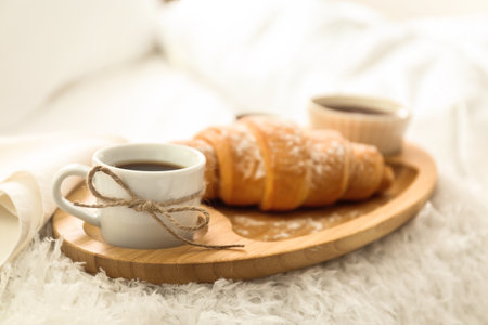 Delicious morning coffee and croissant on bedの写真素材