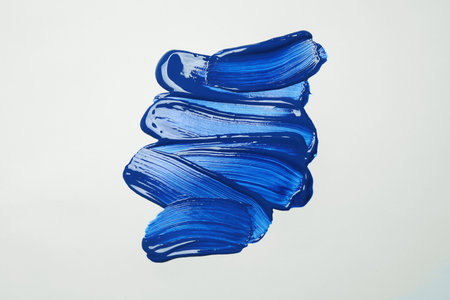 Paint strokes on white background background, top view. Color of the year 2020 (Classic blue)