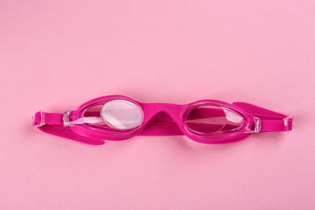 Swimming goggles on pink background, top viewの写真素材