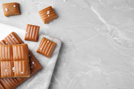 Salted caramel on marble table, flat lay. Space for textの写真素材