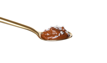 Salted caramel in spoon isolated on whiteの写真素材