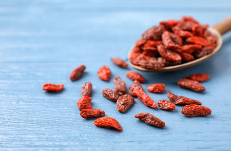 Dried goji berries on blue wooden table, closeupの写真素材