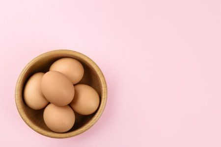 Raw chicken eggs on pink background, top view. Space for textの写真素材